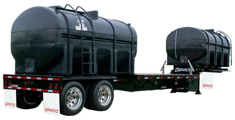 Demco 36-foot liquid tender trailer with black plastic liquid tanks and tandem axles