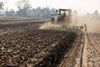 Harrell Ag plow attached to tractor preparing field for planting