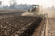 Harrell Ag plow attached to tractor preparing field for planting