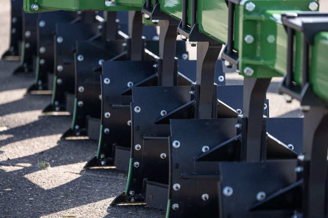 Close-up of Harrell Ag plow moldboards aligned for soil inversion