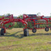 Enorossi CR-850 basket bar rake connected to tractor in field