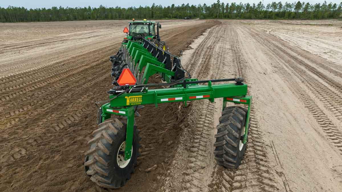Harrell Ag Rock-N-Root Rake rear-mounted view during raking