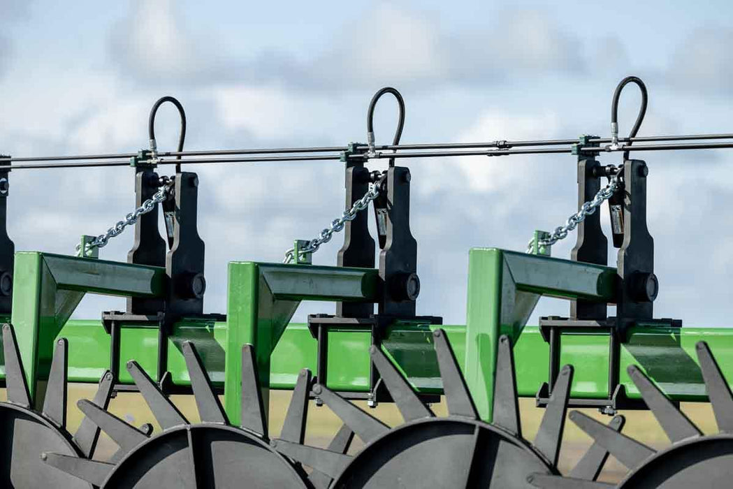 Harrell Ag Rock-N-Root Rake operating across cleared field