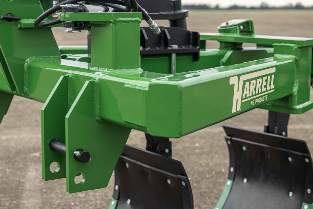 Harrell Ag In-Furrow Land Plow 9400 main frame with Harrell Ag branding and moldboard plow bottoms for tractor tillage.