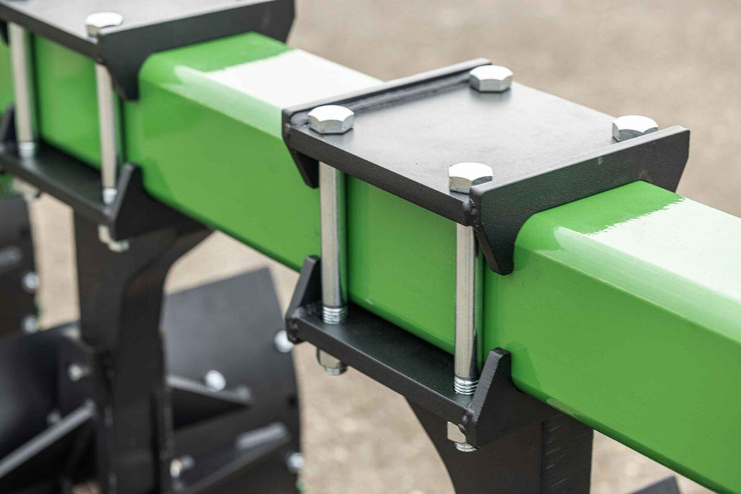 Harrell Ag In-Furrow Land Plow 9400 heavy-duty beam clamps and crossmember securing moldboard assemblies for tractor tillage.