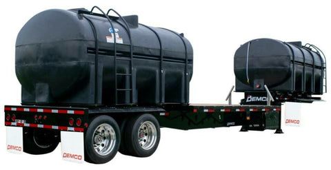 Demco 36-foot liquid tender trailer with black plastic liquid tanks and tandem axles