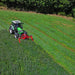 Tractor operating Enorossi front-mounted sickle bar mower in pasture