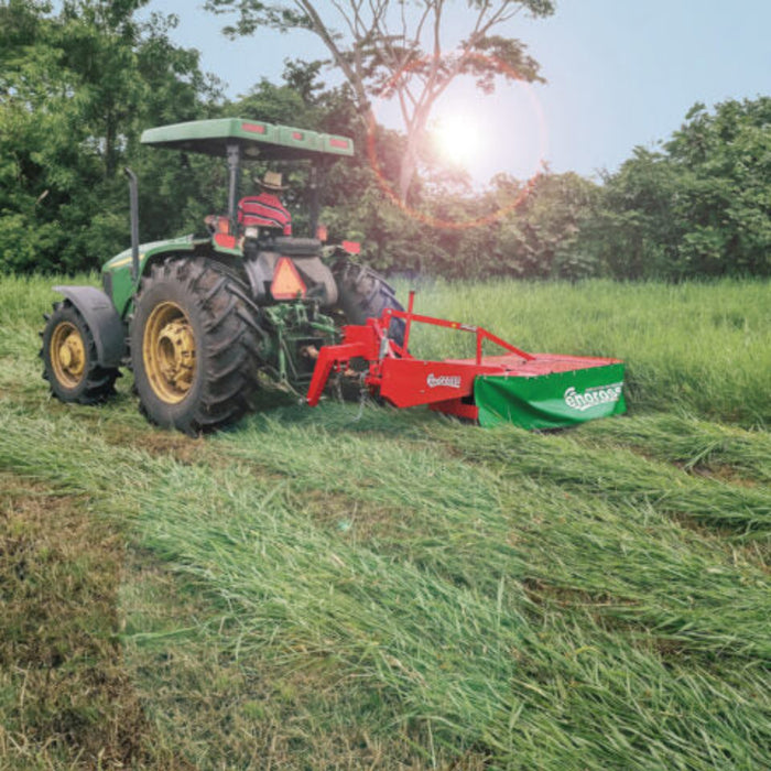Tractor operating Enorossi BT rotary drum mower in pasture field