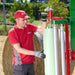 Operator standing beside Enorossi BW bale wrapper after wrapping
