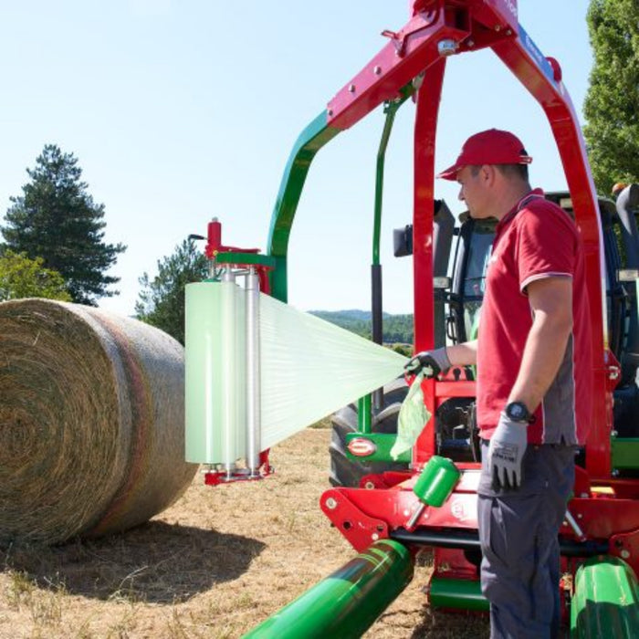 Operator using Enorossi BW mounted bale wrapper in field