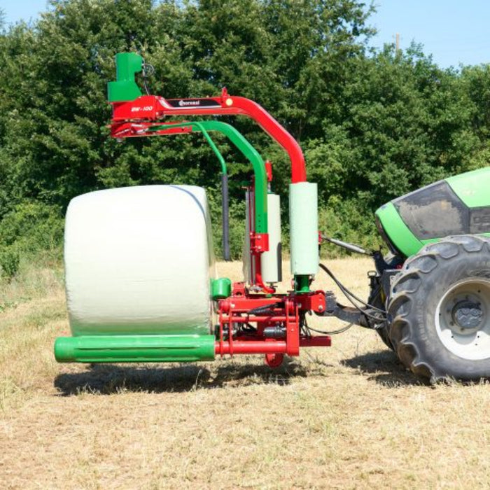 Mounted Enorossi BW bale wrapper applying film to round silage bale