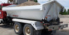 Demco side dump truck box mounted on truck chassis unloading material