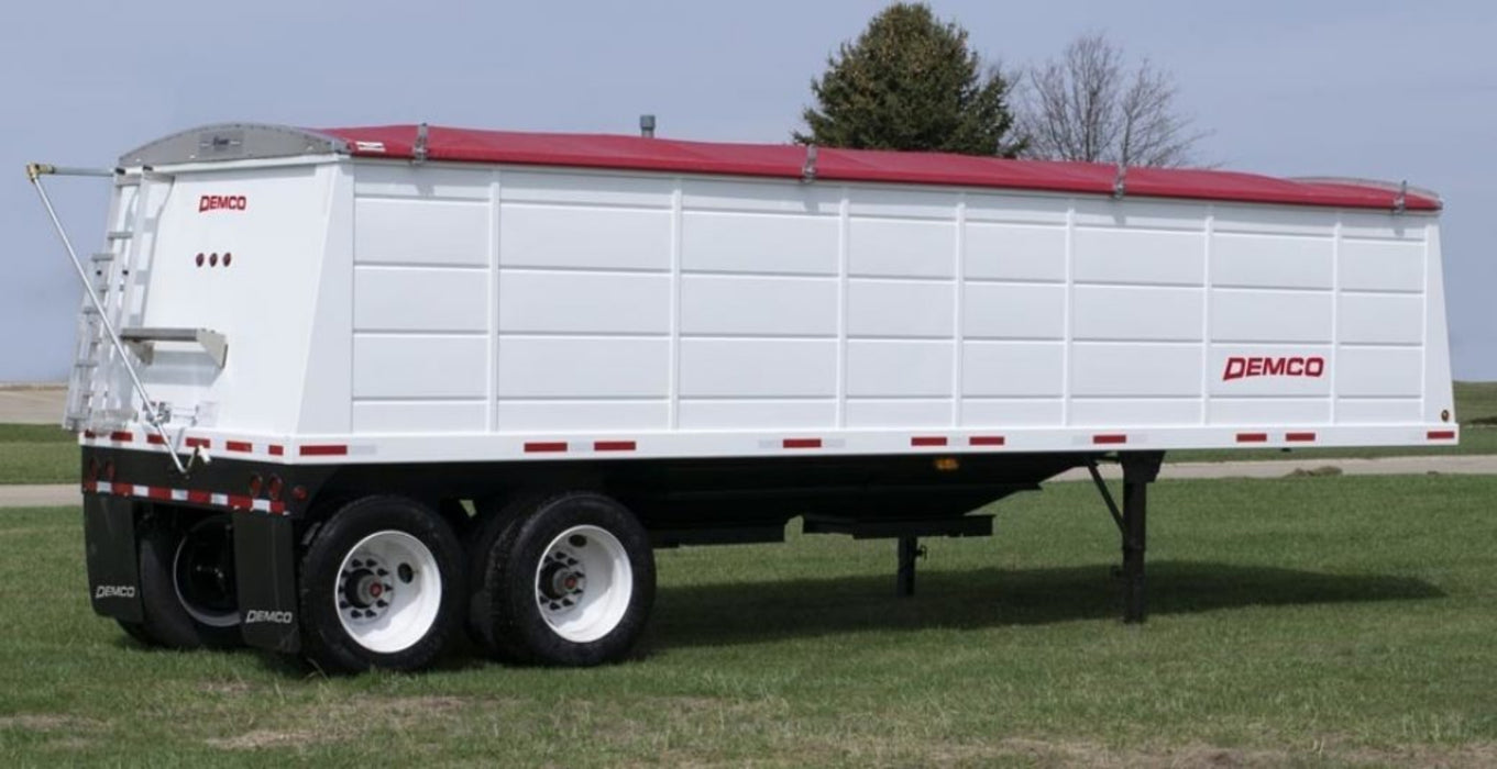 Demco steel hopper-bottom grain trailer rear angle showing hopper and axles
