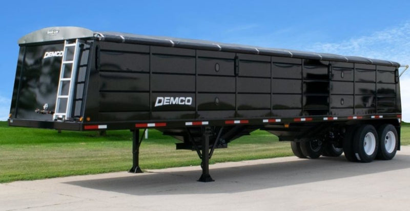 Demco steel hopper-bottom grain trailer side view with tandem axles