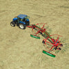Enorossi TRACER 780 double rotary hay rake attached to tractor in field