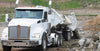 Demco side dump train operating on construction site unloading material