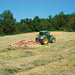 Wheel rake operating on sloped terrain during forage raking