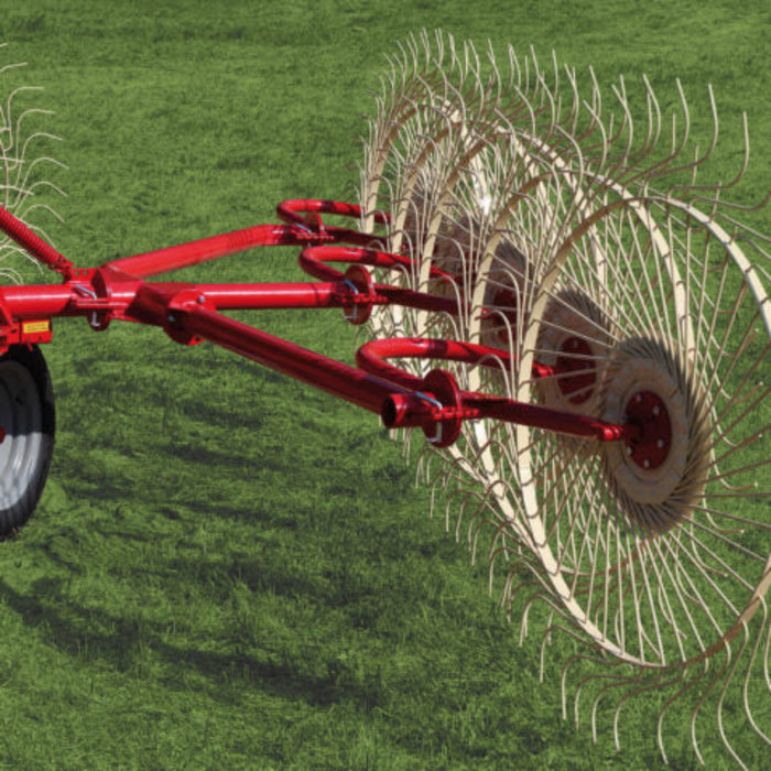Rear angle of Enorossi wheel rake collecting forage into windrow