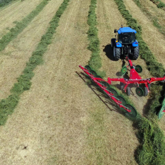 Enorossi MAXIMUS wheel rake attached to tractor in field