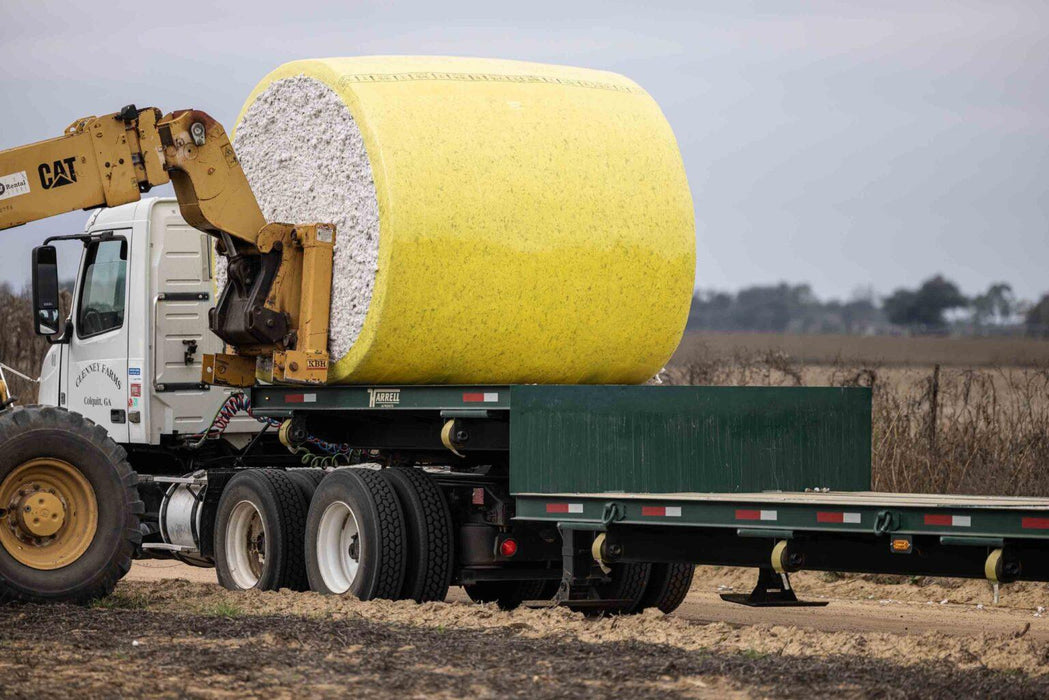 Harrell Ag Module 8 Express cotton module trailer loaded with round cotton module during harvest
