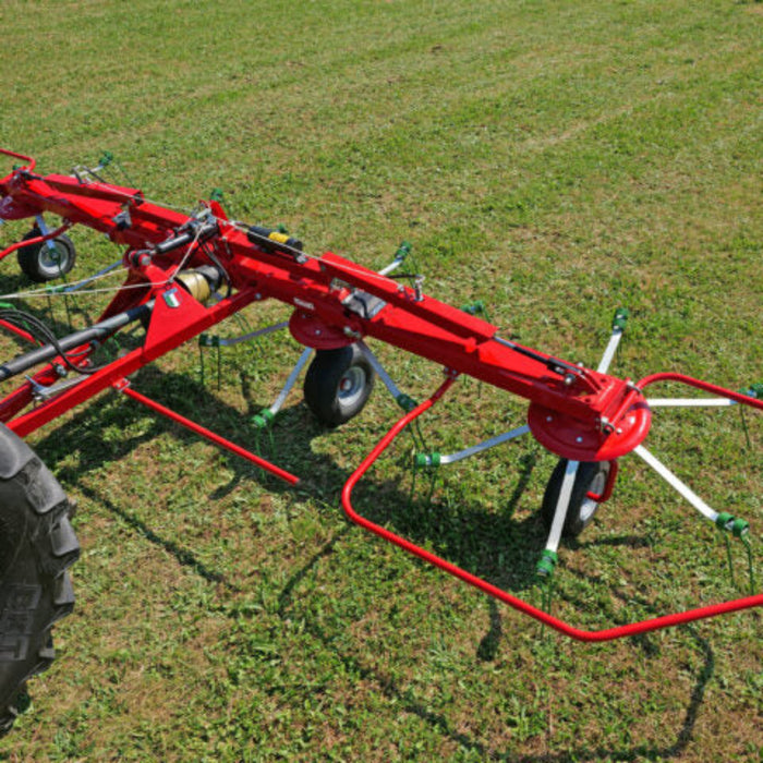 Rear view of Enorossi VORTEX G4 four-rotor hay tedder in operation