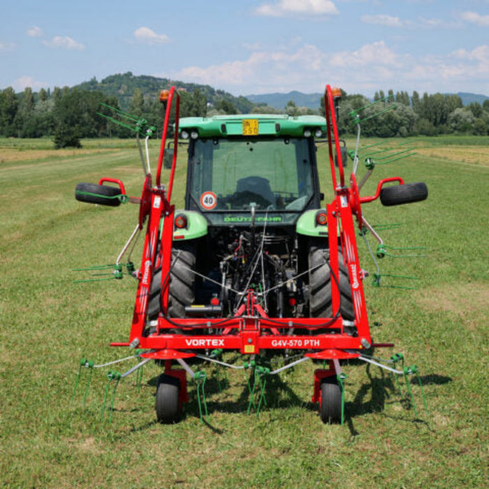 Wide field view of Enorossi VORTEX G4 rotary hay tedder spreading hay
