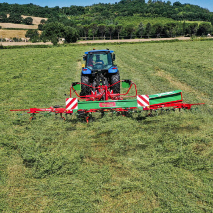 Enorossi VORTEX G6-740 PROFILINE hay tedder operating behind tractor in field